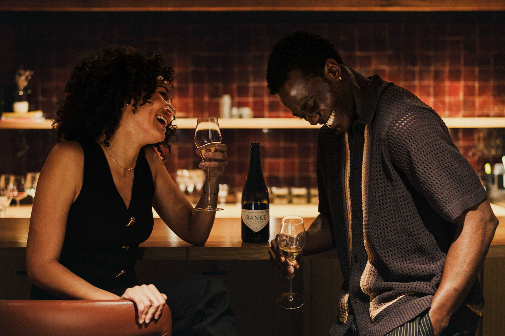 Two friends enjoying Banke wines at a bar
